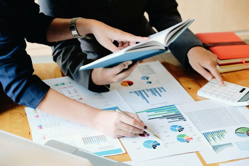 WordPress 安全統(tǒng)計(jì):WordPress 到底有多安全? 兩個(gè)人看著桌子上的統(tǒng)計(jì)報(bào)告。